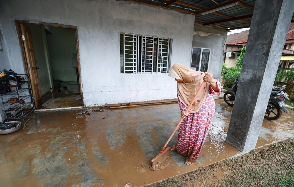 Resident Raihan Anwar, 59, cleans mud from his home following a flash flood during a Bernama survey in Manjoi, Ipoh, February 17, 2026. — Bernama pic