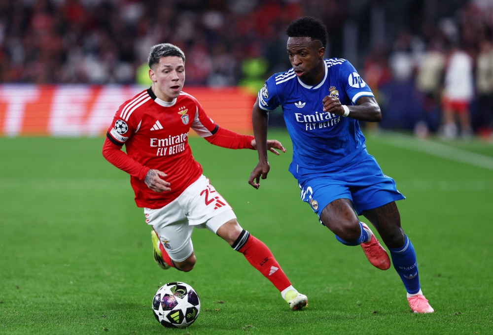 Benfica’s Gianluca Prestianni in action with Real Madrid’s Vinicius Junior during the UEFA Champions League knockout round play-off first leg match at Estadio da Luz in Lisbon on February 17, 2026. — Reuters pic