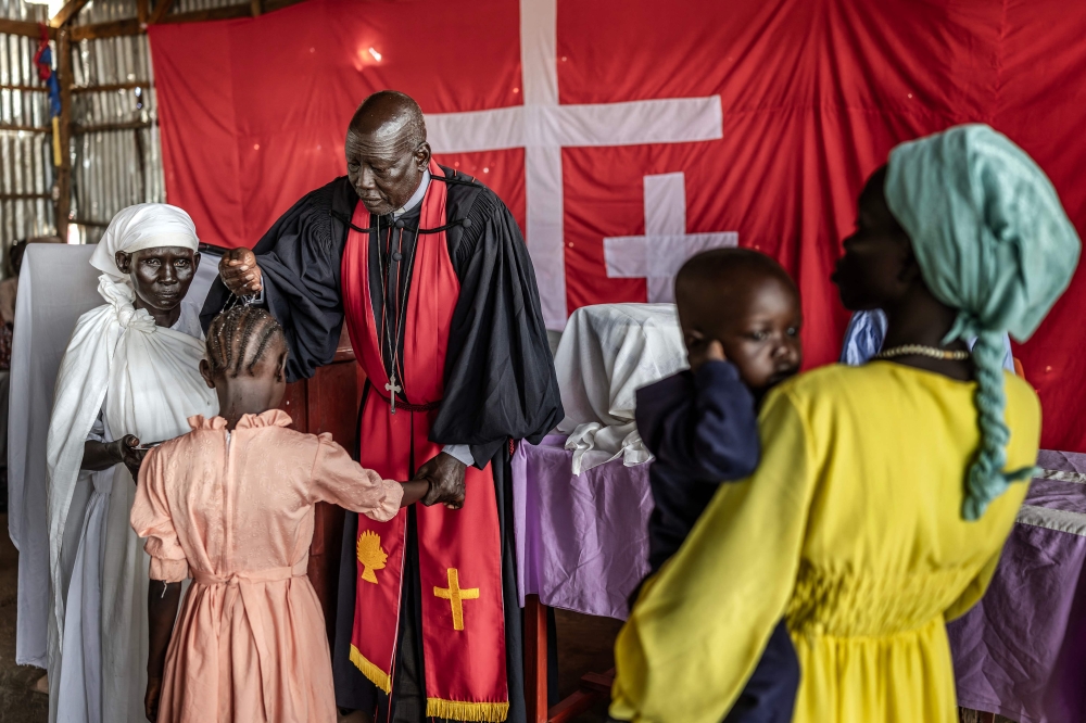 A pastor from the Nuer community, uprooted by the conflict in Jonglei State, baptizes children during a church service for displaced people at the Presbyterian Church of South Sudan. — AFP pic