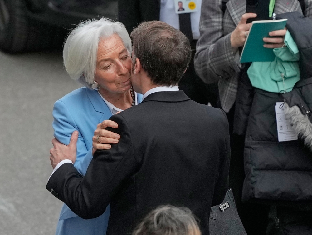 French President Emmanuel Macron and European Central Bank President Christine Lagarde greet each other at the Munich Security Conference in Munich on February 13, 2026. — AFP pic