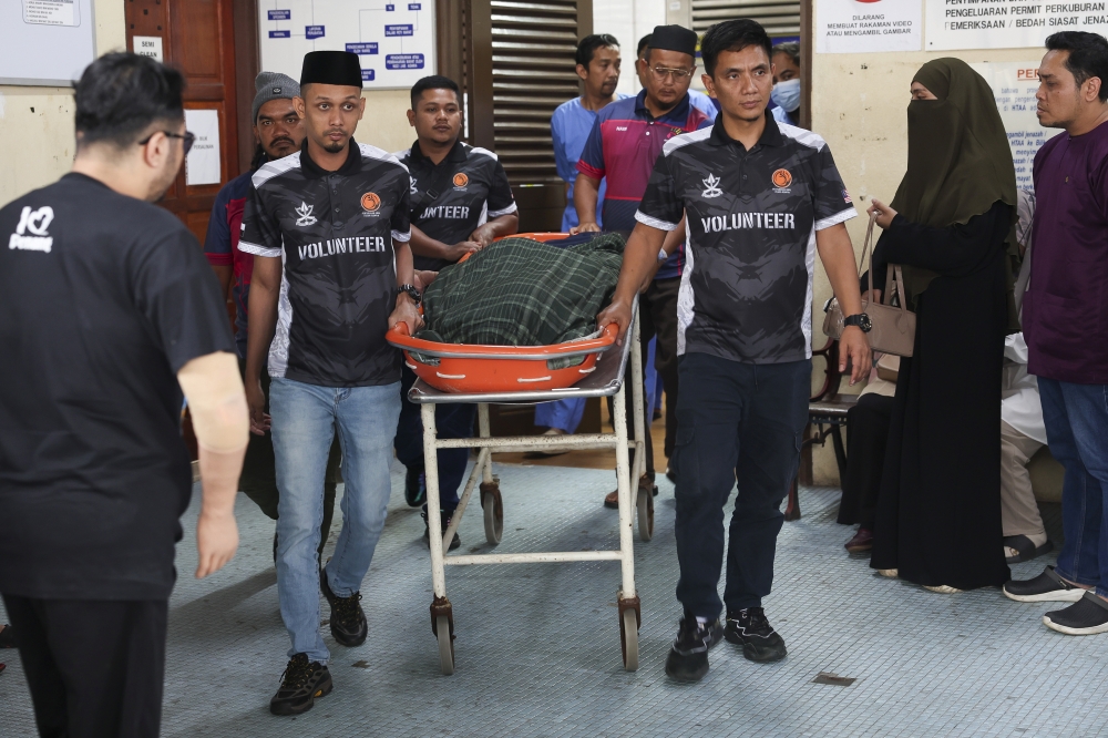 The bodies of five family members involved in a murder at a house in Lorong Cerating Damai here yesterday are carried out after post-mortem examinations at the Forensic Medicine Department of Tengku Ampuan Afzan Hospital (HTAA) at about 3pm today. — Bernama pic