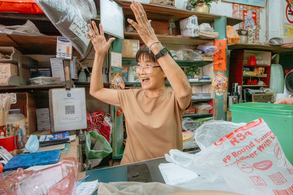 Madam Lau Ai Chu and son Steven welcome the beautiful upgrades to the street. They’ve been in business here for nearly 40 years. — Picture by Raymond Manuel