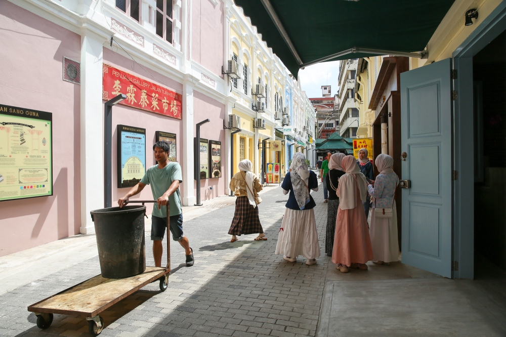 The whole place looks so inviting with buildings given a fresh coat of paint and wall murals telling a story of the history of the area. — Picture by Choo Choy May