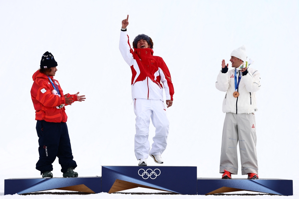 Gold medallist Yiming Su of China celebrates on the podium during the Men’s Snowboard Slopestyle Victory Ceremony with silver medallist Taiga Hasegawa of Japan and bronze medallist Jake Canter of United States, at the Livigno Snow Park, Livigno, Italy, February 18, 2026. — Reuters pic 