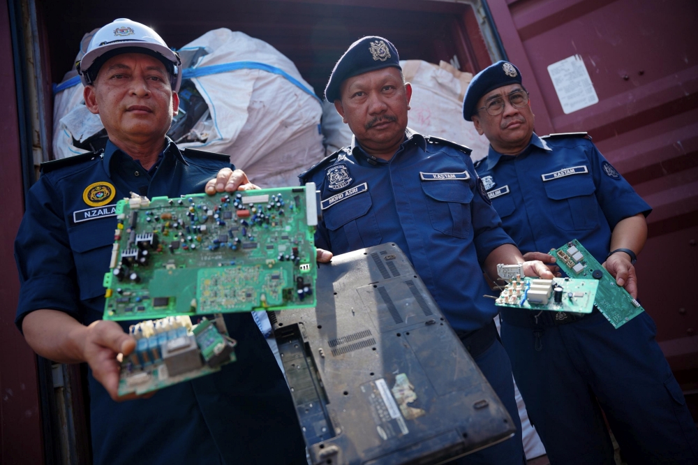 Pahang Royal Malaysian Customs Department Director, Mohd Asri Seman (centre), shows some of the electronic waste in eight 40-foot containers seized during a raid at CP-Hold Yard, North Port, Port Klang on February 3, after a press conference at the CT1 Warehouse, North Port, Port Klang February 19, 2026. — Bernama pic 