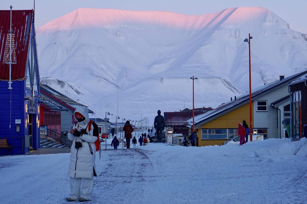 The snow-covered mountains are pictured in the backgound as people way around Longyearbyen on the Norwegian archipelago of Svalbard on February 18, 2026. There are no outward signs of jitters, at least not yet: people in Svalbard are going about their daily lives as normal despite speculation that this Norwegian archipelago could be the next Arctic territory coveted by the US or Russia. — AFP pic 