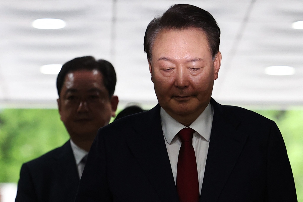 South Korea's former impeached president Yoon Suk Yeol (right) arrives at a court to attend a hearing to review his arrest warrant requested by special prosecutors in Seoul on July 9, 2025. — Kim Hong-ji/Pool/AFP pic 