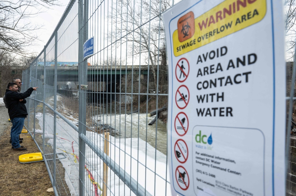 People look on as raw sewage flows out of a drainage pipe into the C&O Canal near Cabin John, Maryland, on February 18, 2026, after 243 million gallons of wastewater spilled into the Potomac River. — AFP pic 
