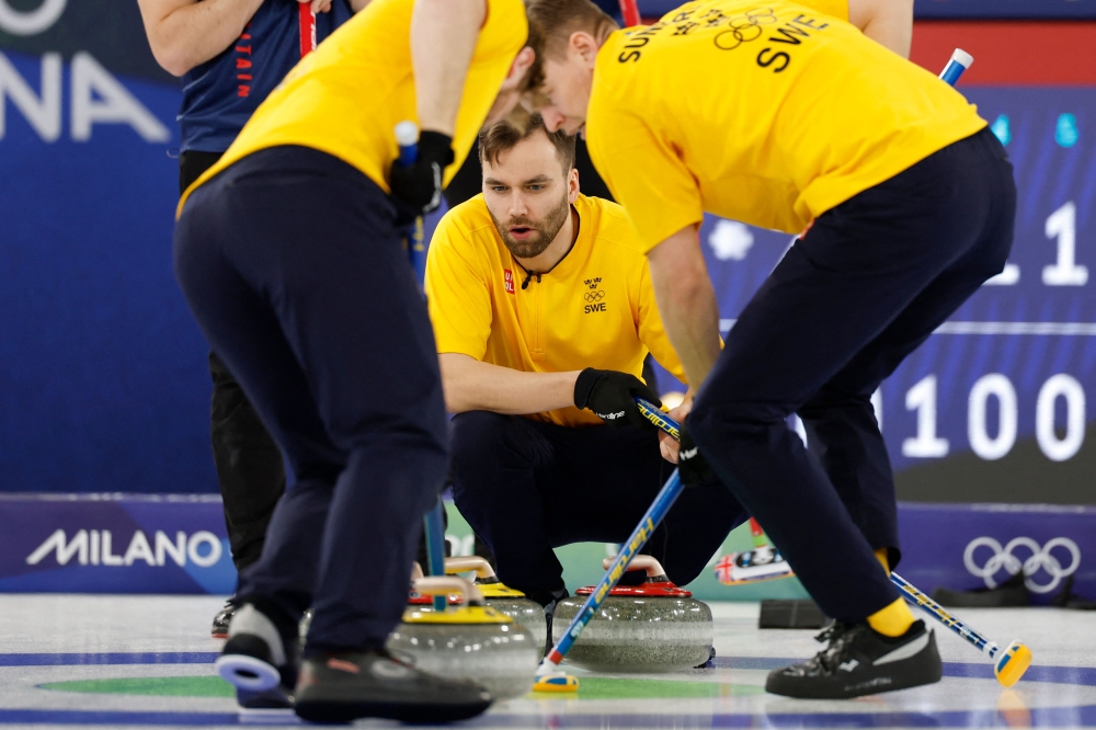Sweden's Oskar Eriksson (C) watches his team mates sweeping during the curling men's round robin between Britain and Sweden during the Milano Cortina 2026 Winter Olympic Games at the Cortina Curling Olympic Stadium in Cortina d’Ampezzo on February 16, 2026. — AFP pic 