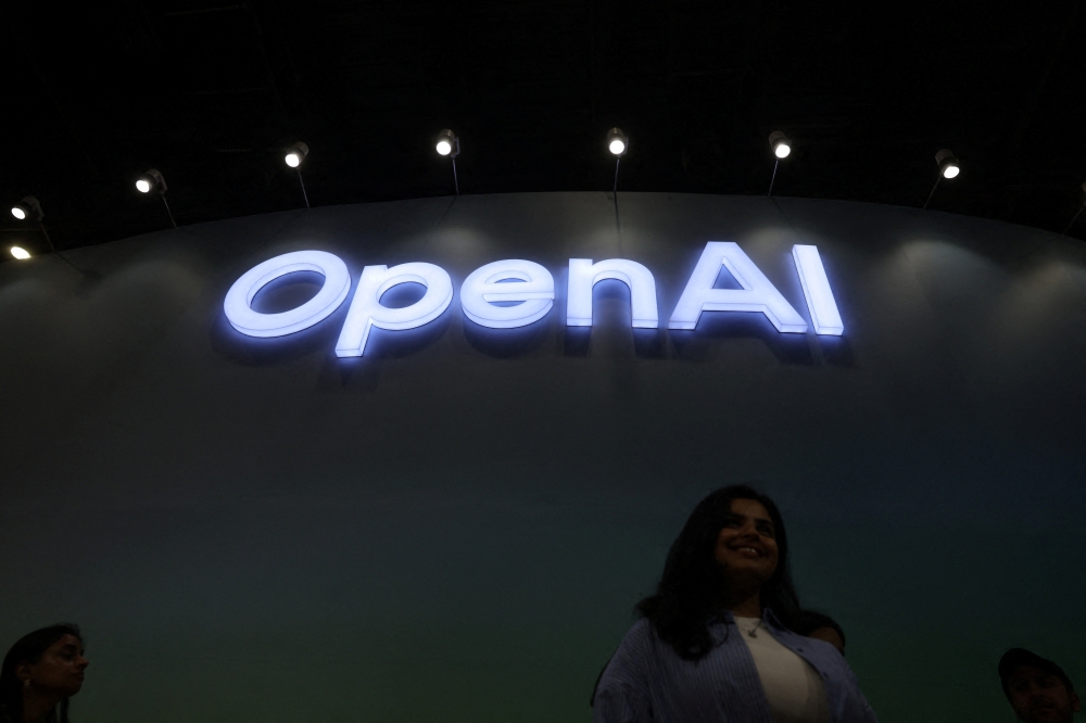 A woman poses for pictures in front of the OpenAI logo at Bharat Mandapam, one of the venues for AI Impact Summit, in New Delhi, India, February 17, 2026. — Reuters pic 