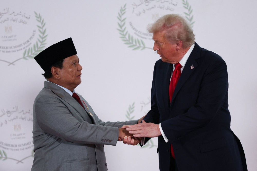 File picture of US President Donald Trump and Indonesian President Prabowo Subianto shaking hands as they pose for a photo, at a world leaders’ summit on ending the Gaza war, October 13, 2025. Indonesian and US companies on Wednesday signed deals worth US$38.4 billion ahead of Prabowo’s meeting with Trump to sign a final trade pact, the Indonesian government said in a statement. — Reuters pic 