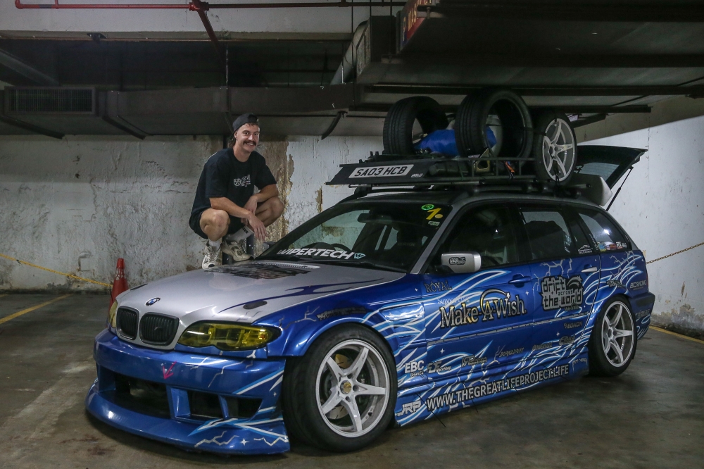 Andy Howard poses for a pictures with his car during an interview with Malay Mail in Kuala Lumpur on February 11, 2026. — Picture by Yusof Isa