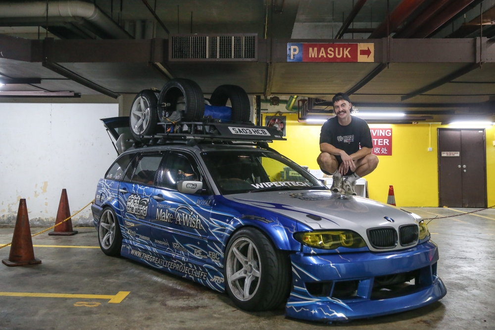 Andy atop his house on wheels, the trusty BMW that will take him across the world to Ireland. — Picture by Yusof Mat Isa
