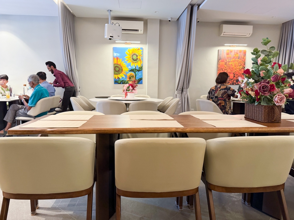 The dining area is designed for large groups that can be separated by a curtain for privacy. 