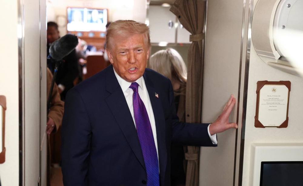 US President Donald Trump speaks to reporters aboard Air Force One, February 19, 2026. — Reuters pic 