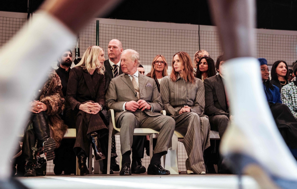 Britain's King Charles III looks on alongside British fashion designer Stella McCartney (R) during the opening show of London Fashion Week 2026, in London yesterday. — AFP pic