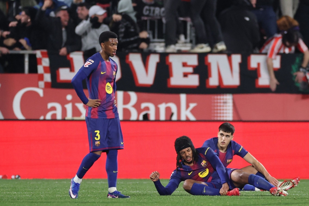 Barcelona players react after conceding a goal from Girona’s Spanish midfielder #08 Fran Beltran (out of frame) during the Spanish league football match between Girona FC and FC Barcelona at Montilivi Stadium in Girona on February 16, 2026. — AFP pic 