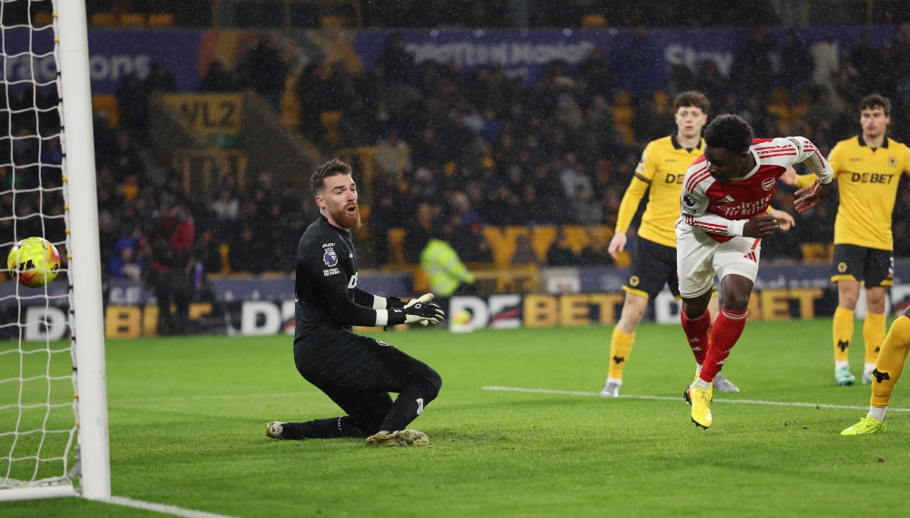 Arsenal’s Bukayo Saka scores their first goal past Wolverhampton Wanderers’ Jose Sa at Molineux Stadium, Wolverhampton, February 18, 2026. — Reuters pic 