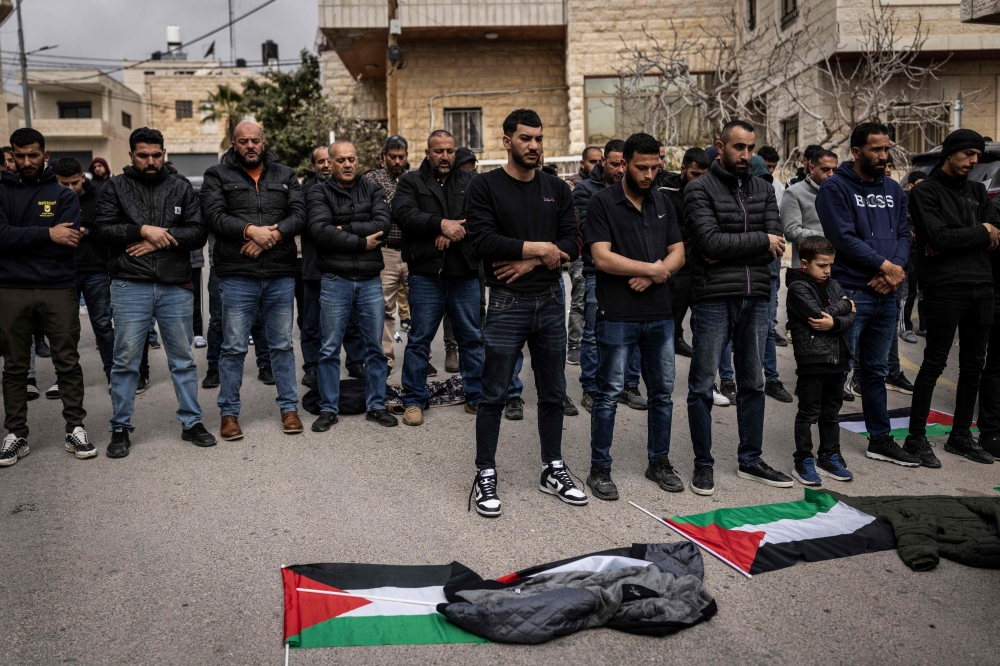Friends and family pray during the funeral of 19-year-old Nasrallah Mohammad Siam, the day after he was killed in an Israeli settler attack, in the village of Mikhams, north-east of Jerusalem, in the Israeli-occupied West Bank on February 19, 2026. — AFP pic 