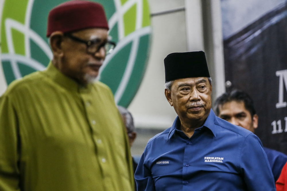 PAS president Tan Sri Abdul Hadi Awang has declined to take over as Perikatan Nasional chairman despite PAS being expected to lead the coalition, following the resignation of Tan Sri Muhyiddin Yassin (right). — Picture by Hari Anggara