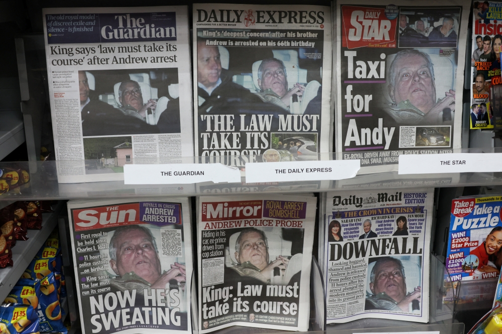 British newspapers, featuring coverage of the arrest of Andrew Mountbatten-Windsor, younger brother of Britain's King Charles, on suspicion of misconduct in public office, sit on display in a newsagent in London February 20, 2026. — Reuters pic 