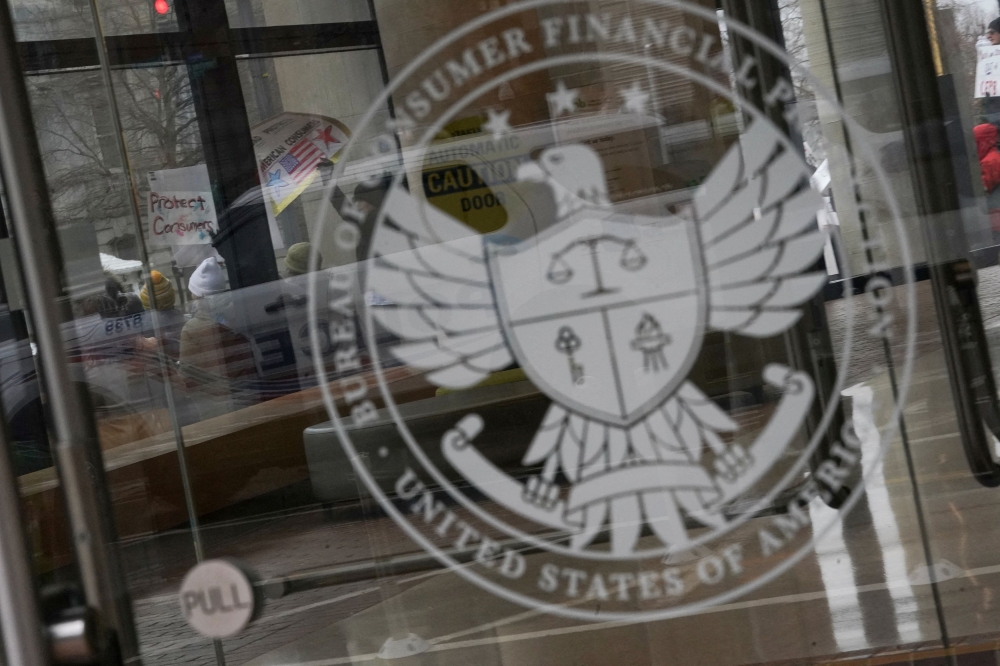 Demonstrators take part in a protest by the Consumer Financial Protection Bureau (CFPB) building, the day after members of Elon Musk's Department of Government Efficiency (DOGE) moved into the CFPB, in Washington February 8, 2025. — Reuters pic