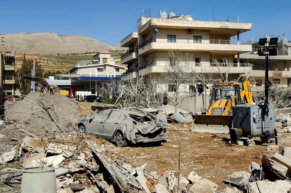 A bulldozer clears debris near heavily-damaged buildings in the village of Bednayel in Lebanon's eastern Bekaa Valley region on February 21, 2026, following Israeli strikes. — AFP pic 