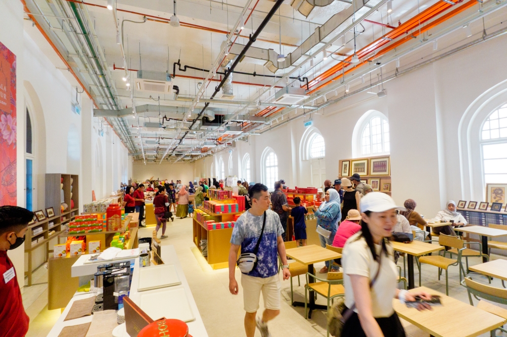 Visitors browse souvenirs and gather at a café inside the Sultan Abdul Samad Building. — Picture by Raymond Manuel