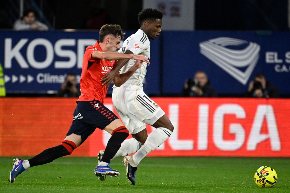 Osasuna’s Spanish midfielder #10 Aimar Oroz (L) and Real Madrid’s French midfielder #14 Aurelien Tchouameni fight for the ball during the Spanish league football match between CA Osasuna and Real Madrid CF at El Sadar Stadium in Pamplona on February 21, 2026. — AFP pic