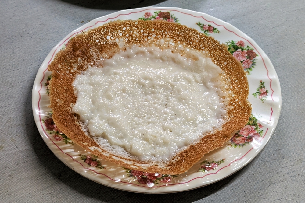The special ‘appam’ at Esther’s Appam Stall comes topped with coconut milk in the centre. — Picture by Ethan Lau