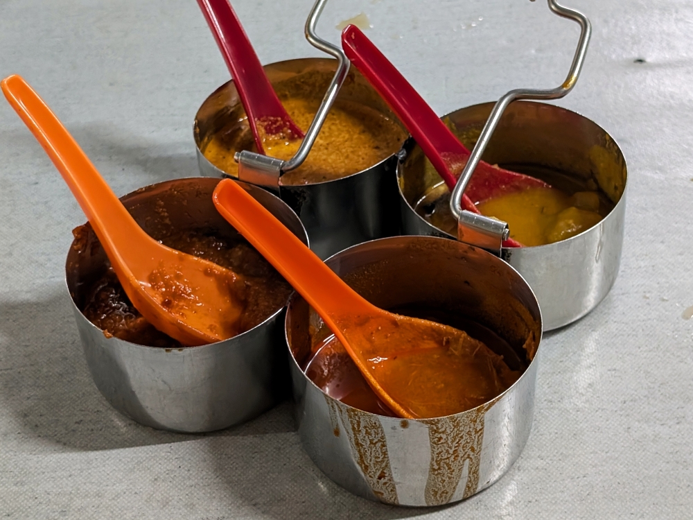 Don’t miss out on the condiments: ‘dal’, chicken curry, coconut chutney and ‘sambal’. — Picture by Ethan Lau