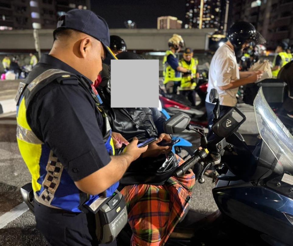 JPJ officers inspect motorcycles during a Chinese New Year enforcement operation at the Sentul Pasar Toll Plaza in Kuala Lumpur February 21, 2026. — Picture via Facebook/JPJWPKL