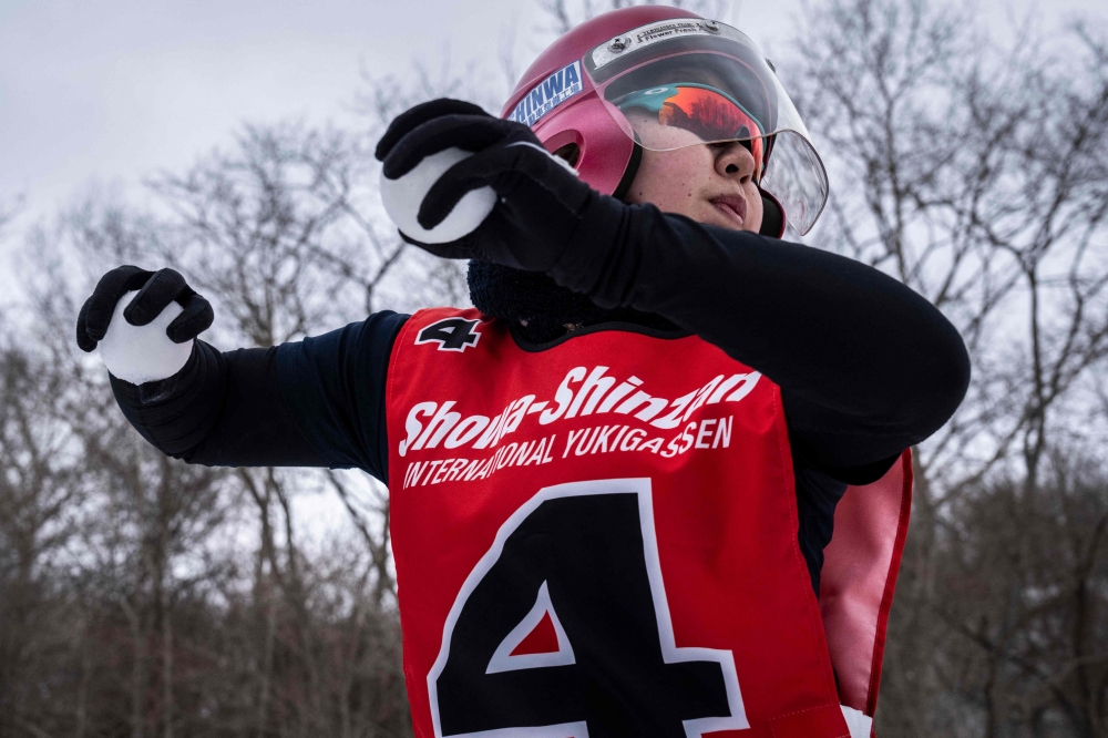 A player throws a snowball during the Showa-shinzan International Yukigassen competition in Sobetsu, Hokkaido prefecture on February 21, 2026. — AFP pic