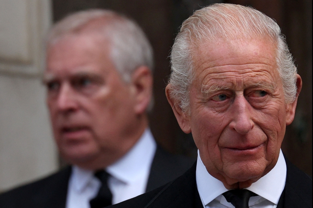 King Charles III (right) faces the most serious test after the arrest of his brother Andrew (left), the latest in a series of painful personal shocks to mar his reign. — AFP pic