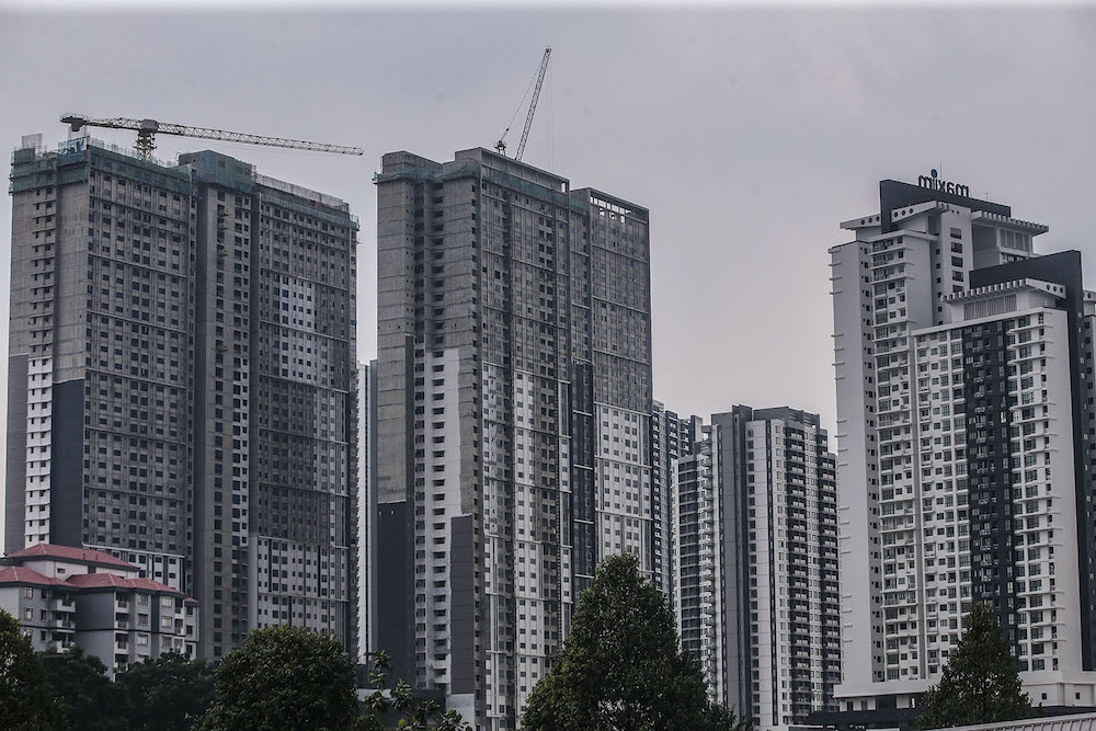 A view of high-rise apartments under construction in Kuala Lumpur. Under Malaysia’s strata system, individual unit owners hold title to their parcels while jointly managing common property through a management corporation. — File picture by Hari Anggara