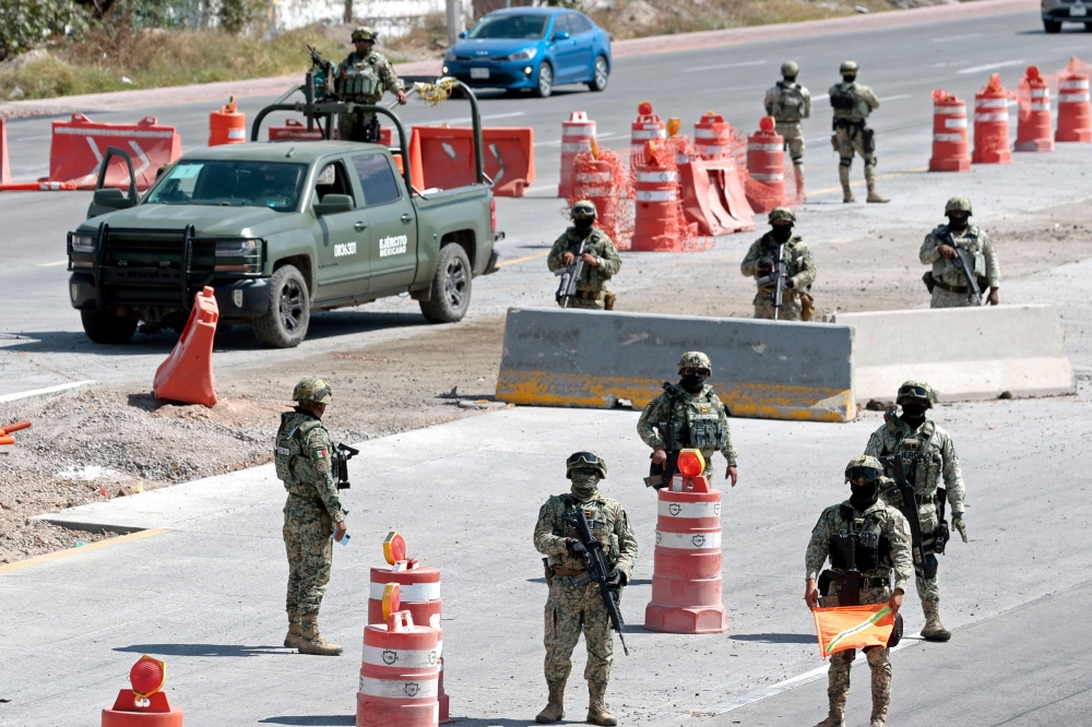 Mexican Army personnel stand guard at the access roads to the Guadalajara International Airport in Tlaquepaque, Jalisco State, Mexico, yesterday. — AFP