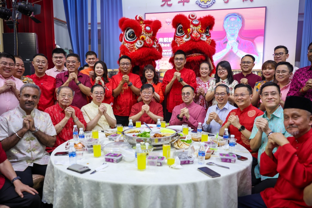 Penang DAP chairman Steven Sim (seated fifth from right) with Penang Chief Minister Chow Kon Yeow (seated fourth from left) and Penang DAP committee members at the Penang DAP Chinese New Year Open House at SJK (C) Kwang Hua on February 22, 2026. — Berrnama pic
