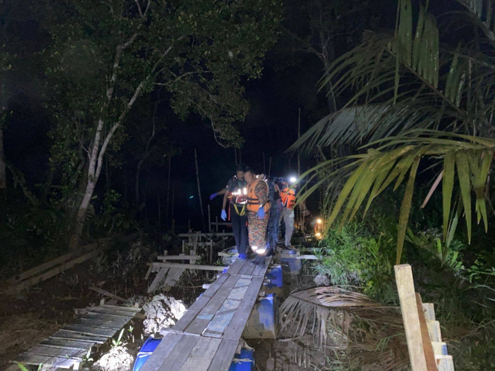 Searchers recovered the body of Albert Tan Siang Fook, 56, just 200 metres from where he fell into the river while fishing with his nine-year-old son at Jeti Bumbung Biru in Tanjung Ayer Hitam, Johor on February 22, 2026. — Picture from Facebook/Balai Bomba Penyelamat Pontian