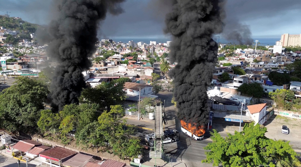 Smoke billows from burning vehicles amid a wave of violence, with torched vehicles and gunmen blocking highways in more than half a dozen states, following a military operation in which a government source said Mexican drug lord Nemesio Oseguera, known as ‘El Mencho,’ was killed, in Puerto Vallarta, Jalisco, Mexico, February 22, 2026, in this screen grab obtained from a social media video. — Reuters pic
