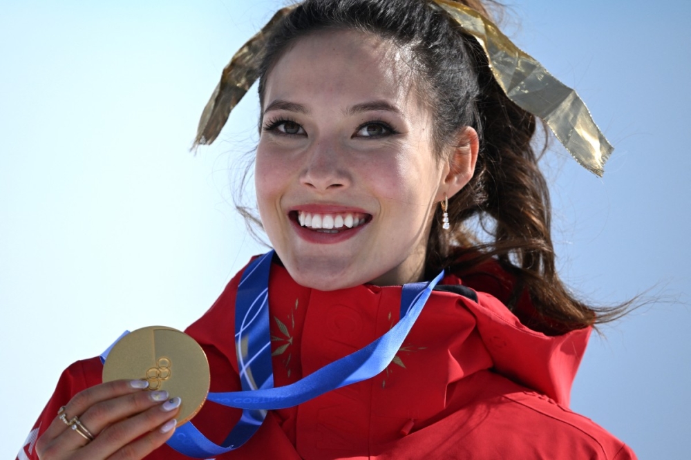 Gold medallist China’s Eileen Gu celebrates on the podium after winning the freestyle skiing women’s freeski halfpipe final during the Milano Cortina 2026 Winter Olympic Games in Livigno February 22, 2026. — AFP pic