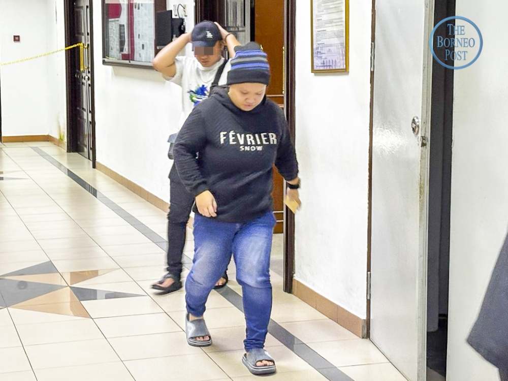 Holinesilla exits the courtroom after proceedings at the Kuching Court Complex. — The Borneo Post pic