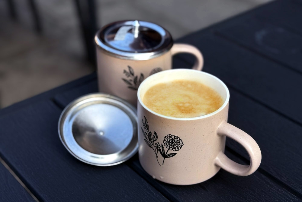 Nescafe ‘tarik’ served in ceramic mugs with metal lids. — Picture by CK Lim