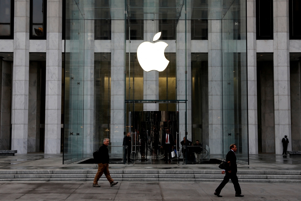The Apple Inc logo is seen hanging at the entrance to the Apple store on 5th Avenue in Manhattan, New York, October 16, 2019. Apple will move some production of its Mac Mini desktop computer to the US from Asia, with a new manufacturing effort set to begin later this year at a Foxconn facility in north Houston — Reuters pic 