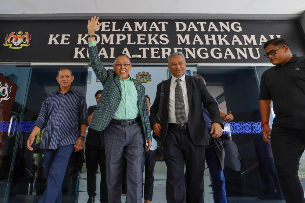 Terengganu Infrastructure, Utilities and Rural Development Committee chairman Datuk Hanafiah Mat (second from left) was charged with two counts of using his position to obtain bribes for his two sons in 2018 and 2020. — Bernama pic
