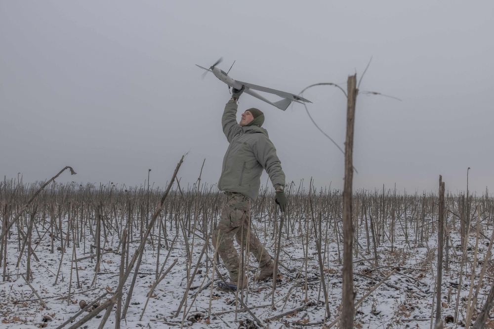 A Ukrainian member of an Azov Brigade drone team — callsign Sava, 21, launches a surveillance drone towards Russian positions, in the direction of Toretsk, eastern Donetsk region, on February 4, 2025. — AFP pic