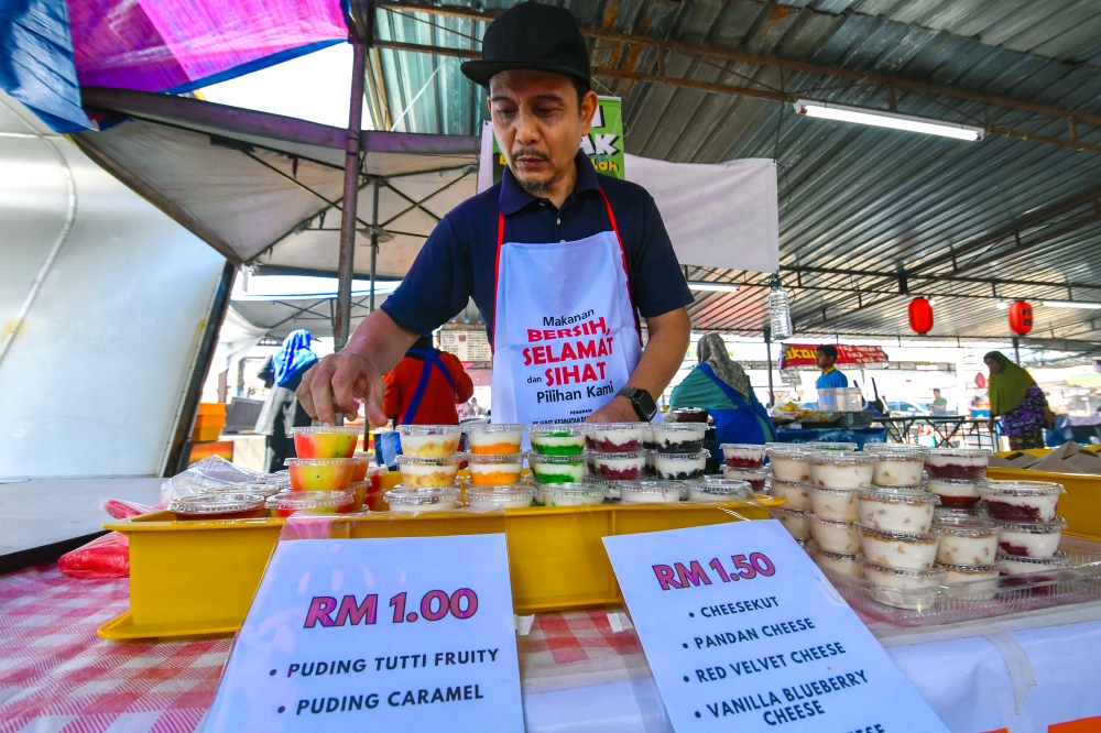 Trader Nazrulaman Mohamed arranges cakes and puddings priced between RM1 and RM1.50 when met by Bernama at the Peringat Ramadan Bazaar in Kota Bharu. — Bernama pic