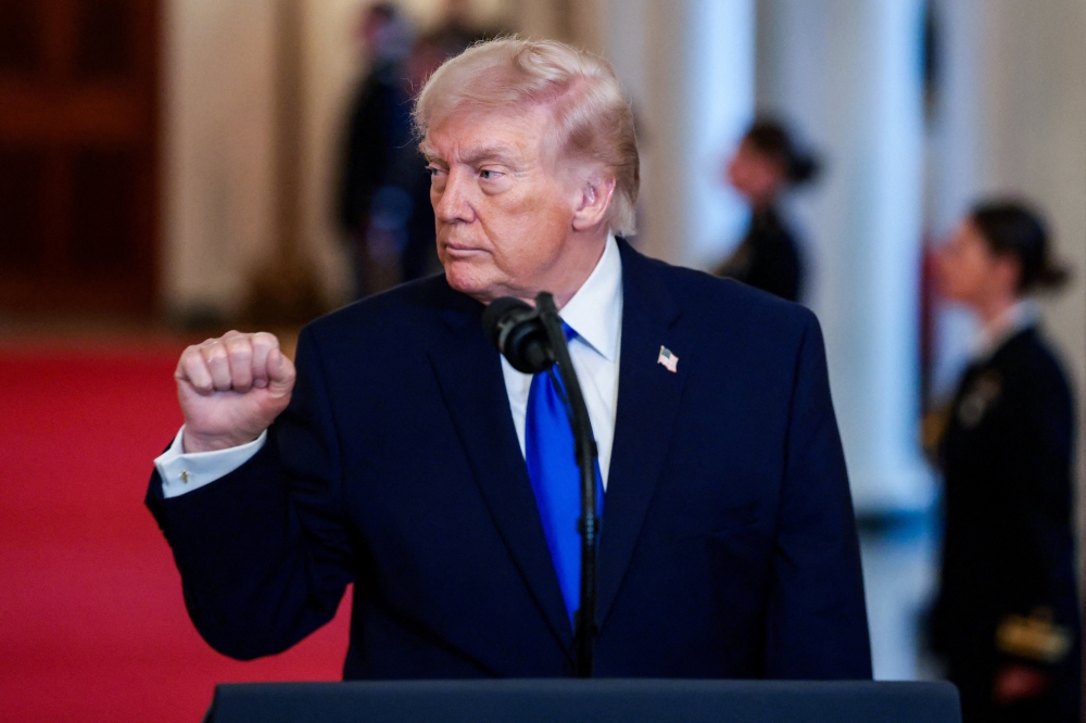 Donald Trump is set to defend a turbulent 13 months in office as he prepares to deliver his State of the Union address. — Reuters pic