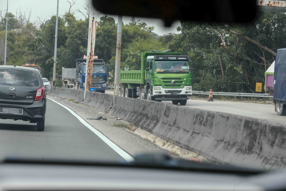 Tipper trucks are seen in the area during Ops Middleman in Nilai, Negeri Sembilan on February 24, 2026. — Picture by Sayuti Zainudin