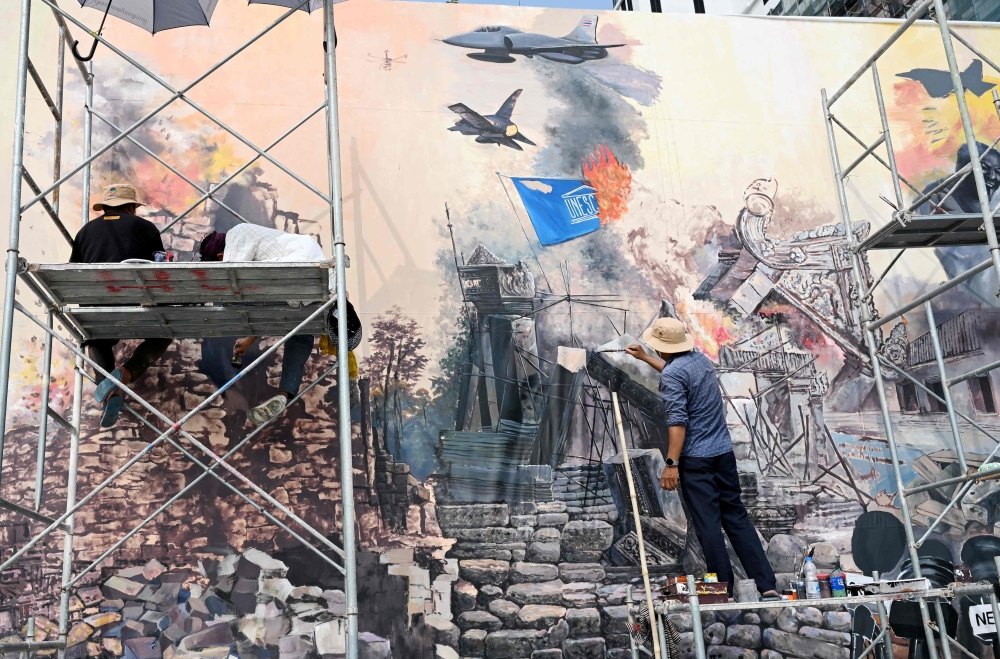 Artists work on a mural under the theme ‘Art for Peace’ depicting the conflict between Cambodia and Thailand at a park in Phnom Penh on February 24, 2026. Thailand’s army said it exchanged fire with Cambodian forces along their border on Tuesday, accusing its neighbour of violating a December truce. — AFP pic 