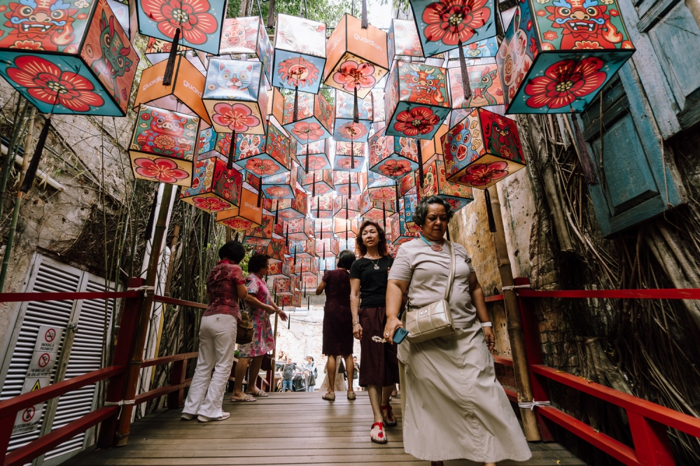 Visitors walk beneath an installation of Chinese New Year lanterns along an alleyway in Kuala Lumpur February 5, 2026. — Picture by Raymond Manuel